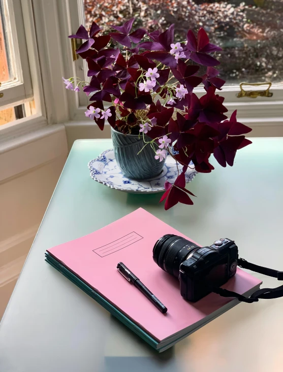 a table with some flowers and a notepad