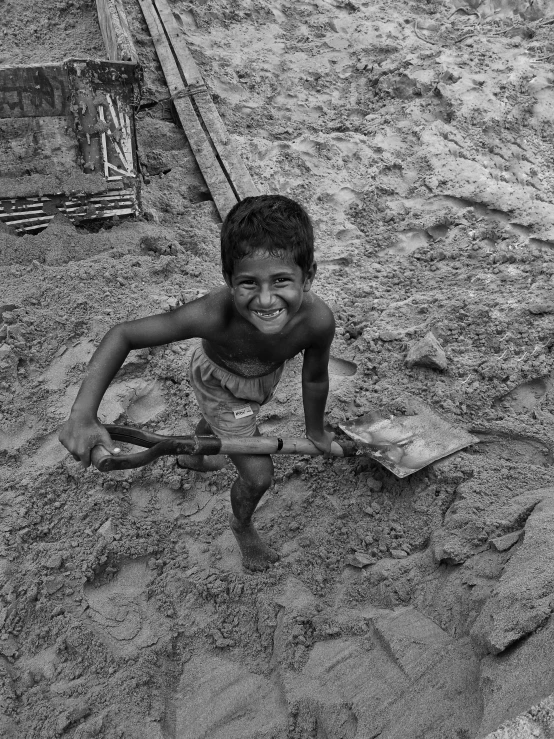 a young child that is playing with some sand