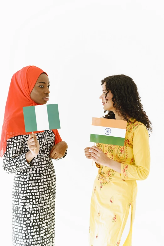 two women holding flags and looking at each other