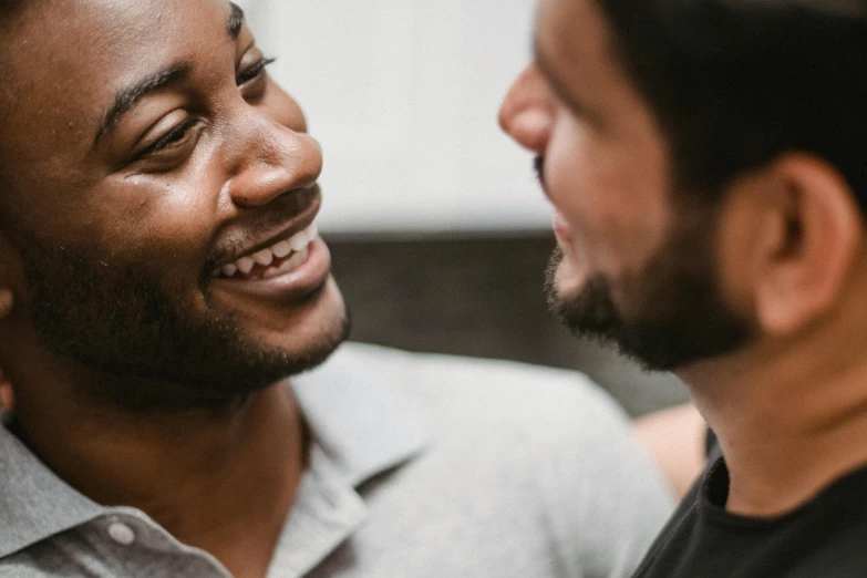 two men are smiling and laughing as one laughs