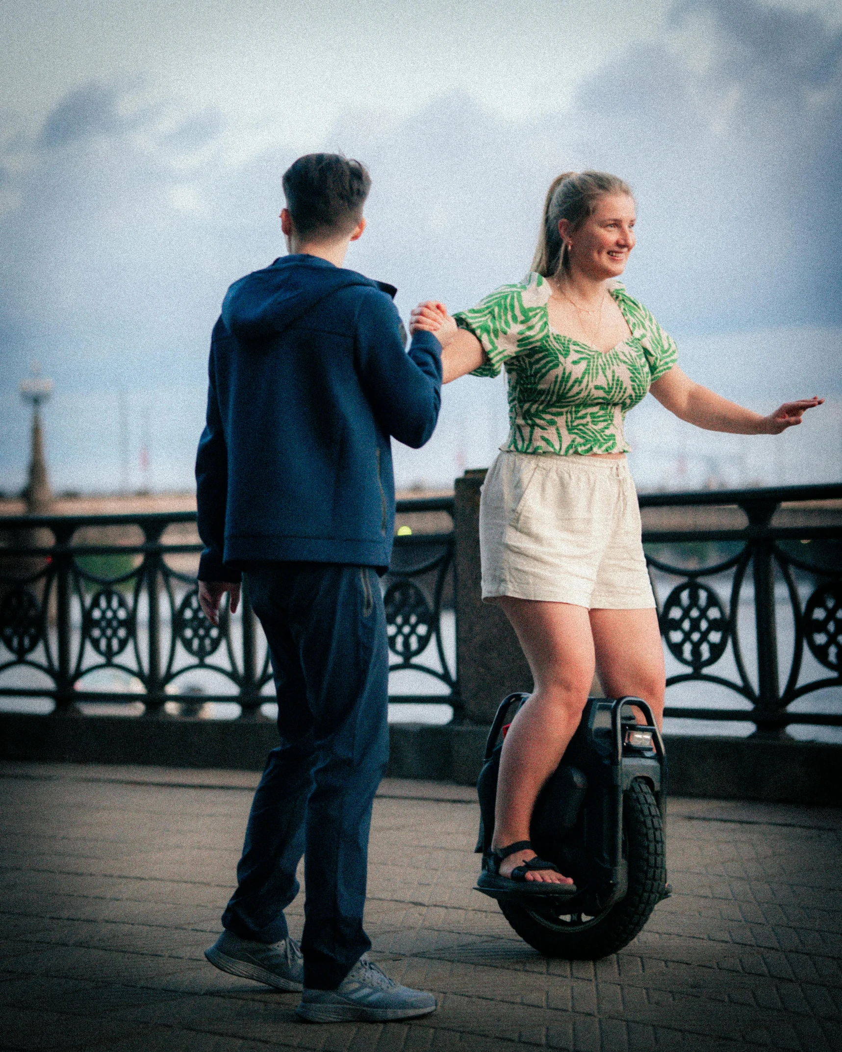 a man on an electric scooter next to a woman