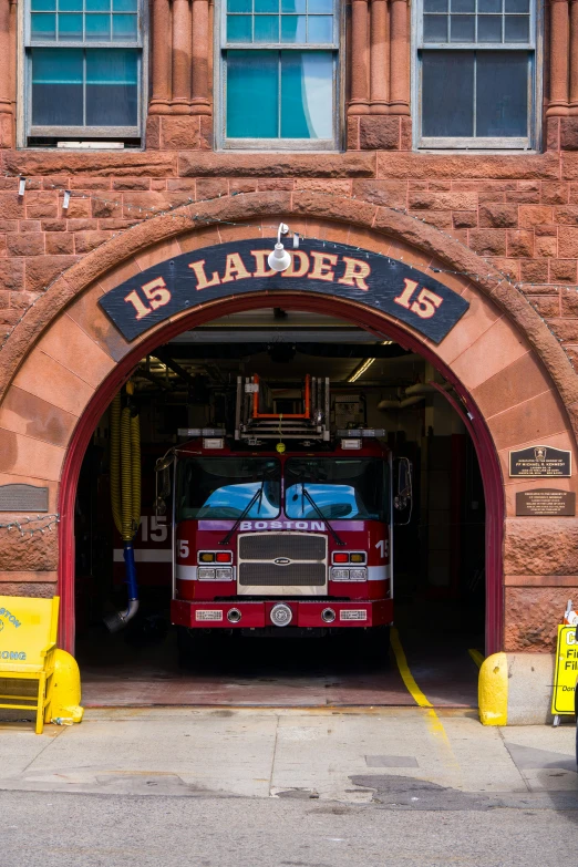 a red fire truck is parked under an arch