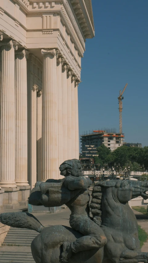 two statues outside of a building in front of it