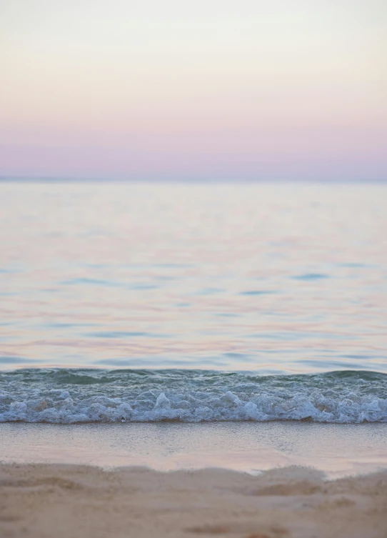 a person with a surfboard walking towards the water