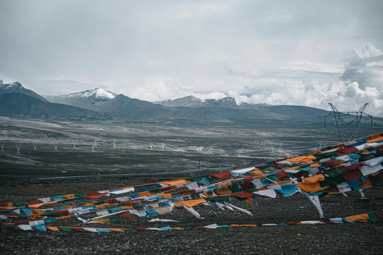 flags are in front of mountains and wires