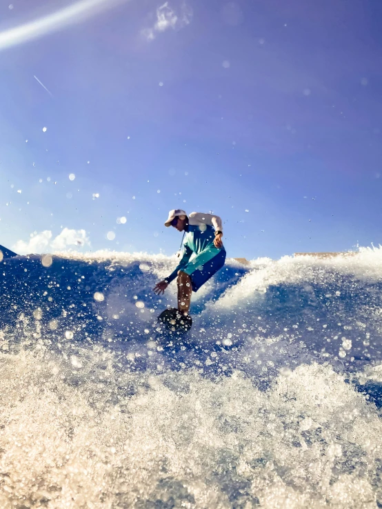 a man is surfing in the ocean with a sky background