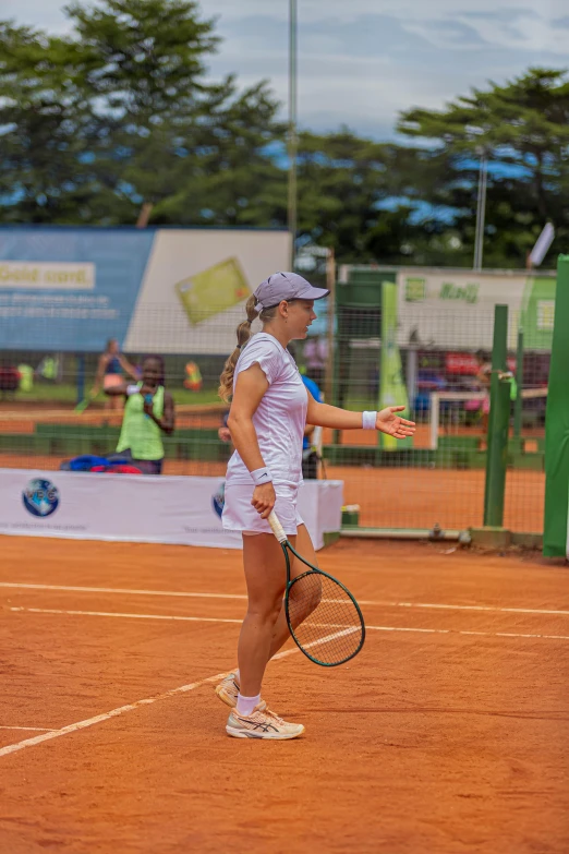 a woman holding a tennis racquet on a court