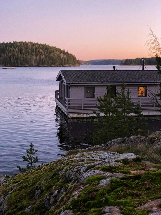 a dock in front of some small houses with trees