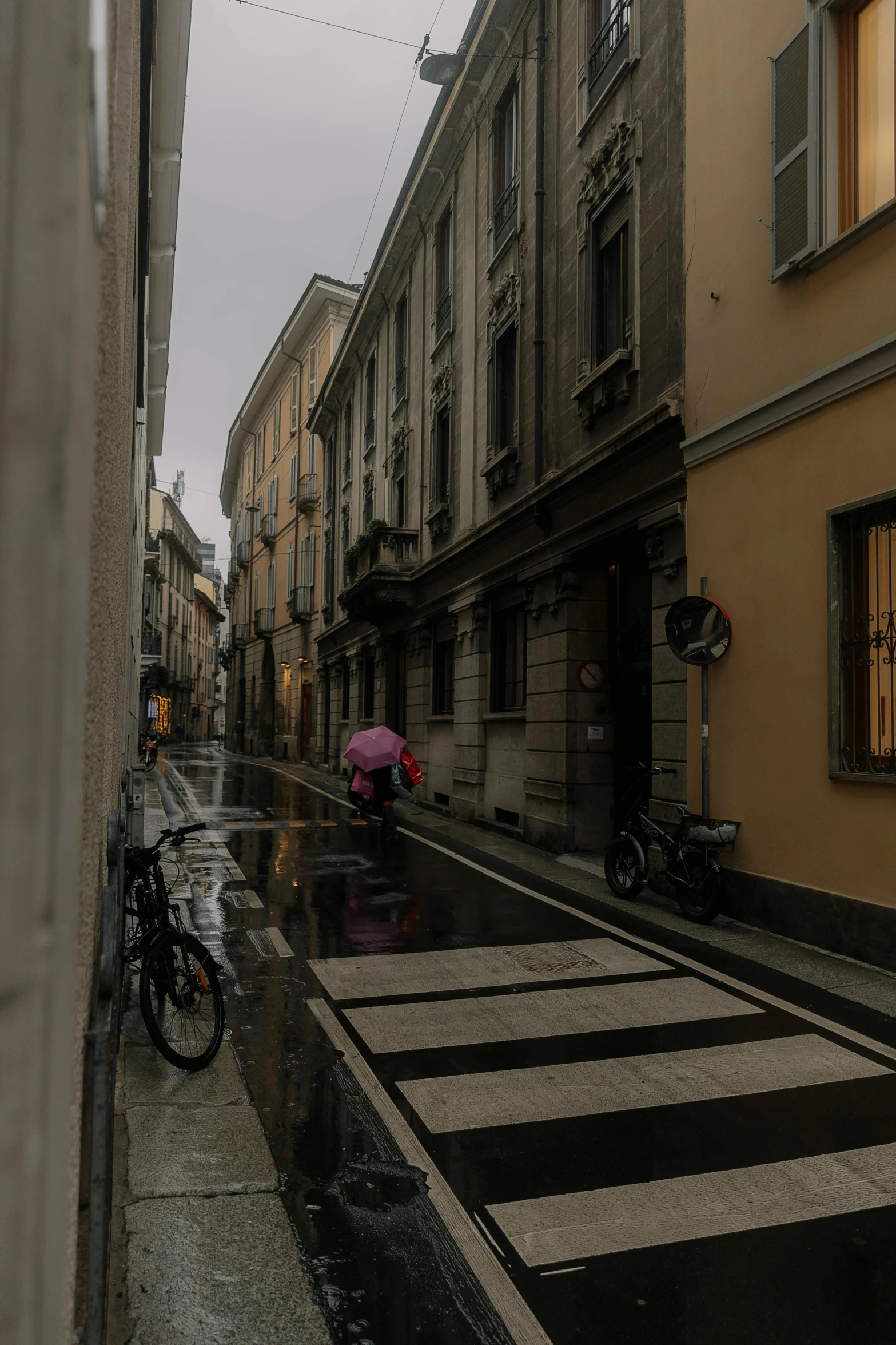 a person is walking on a rainy day with an umbrella