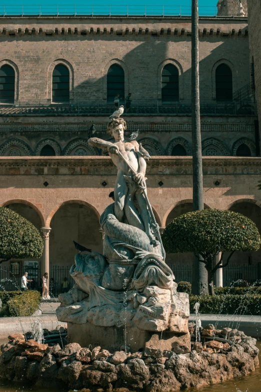 a fountain has a statue in it that is outside