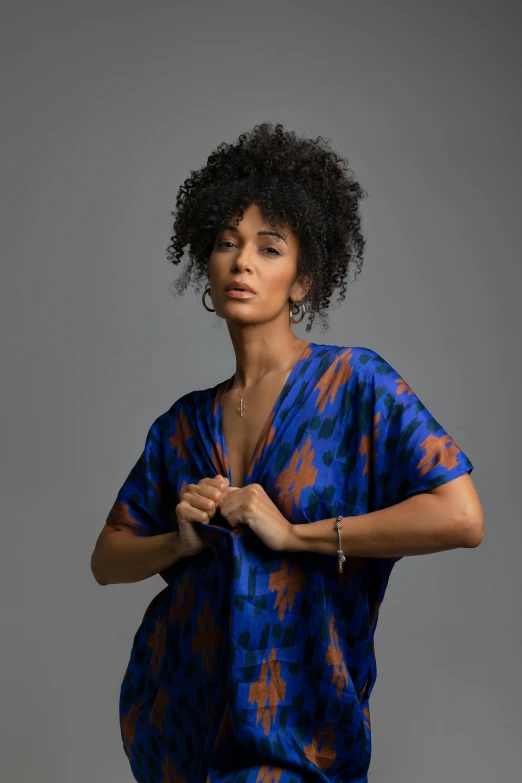 an african american woman standing in a studio