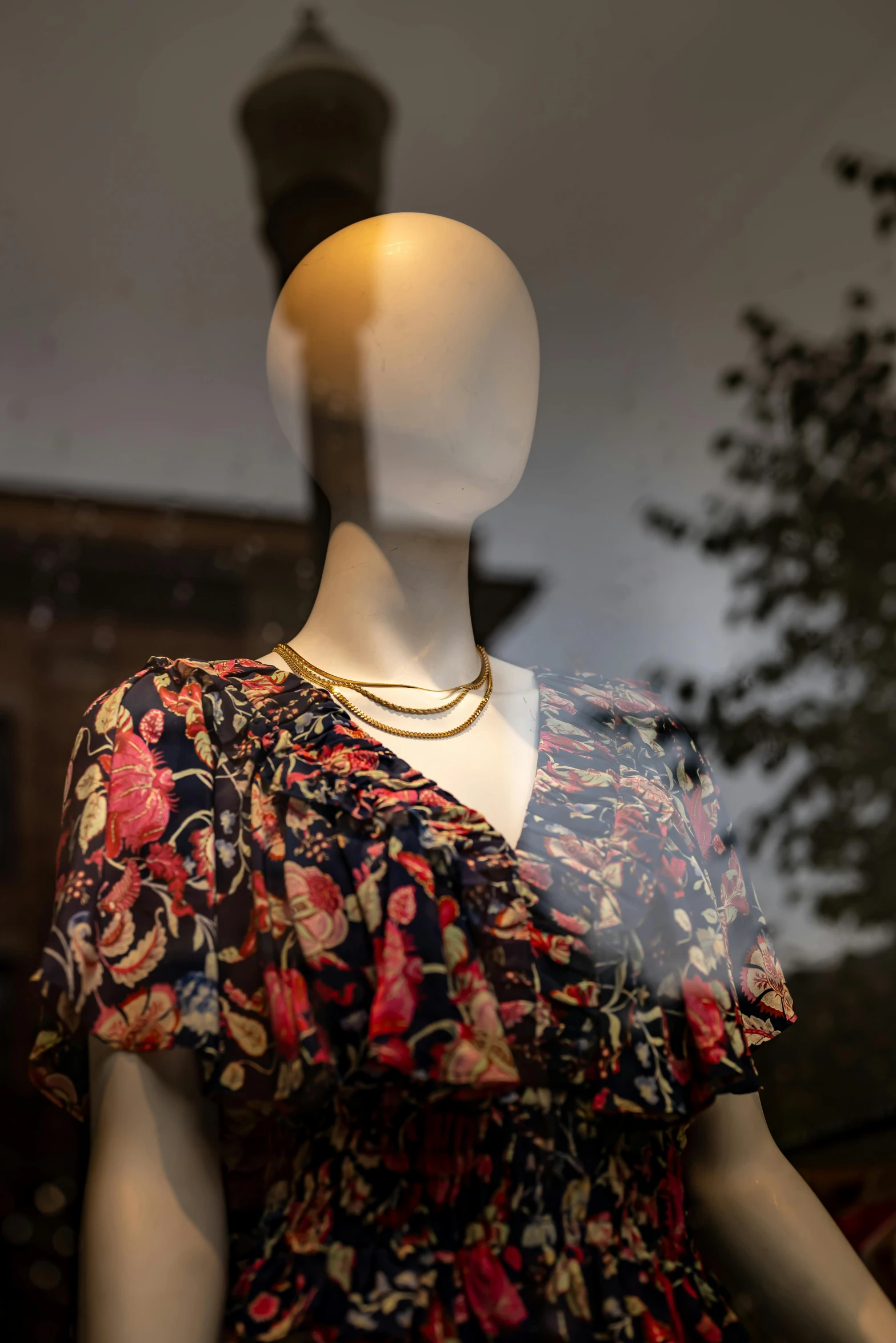 a mannequin's head with a colorful dress on it