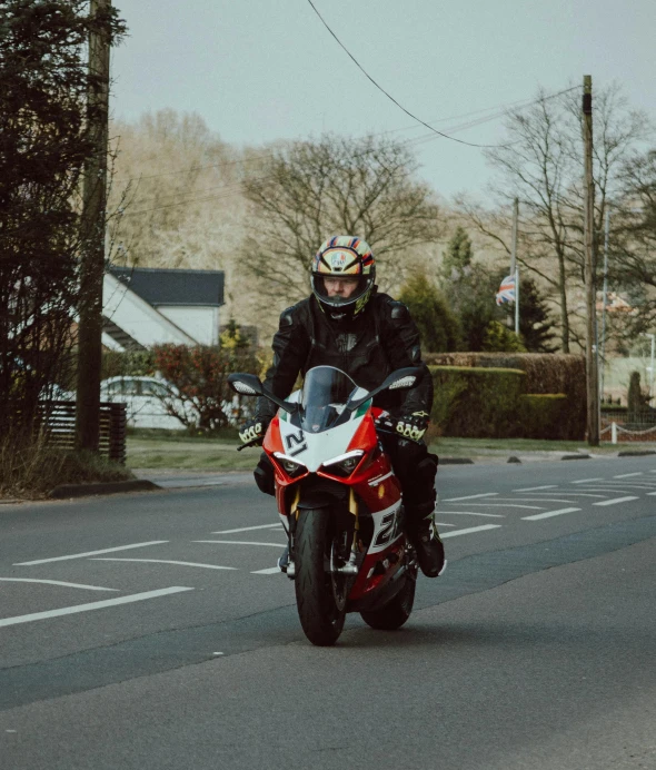 a man is riding on his motorcycle down the street