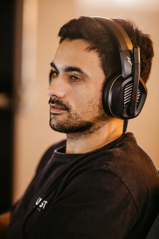 a man wearing headphones and staring at the camera