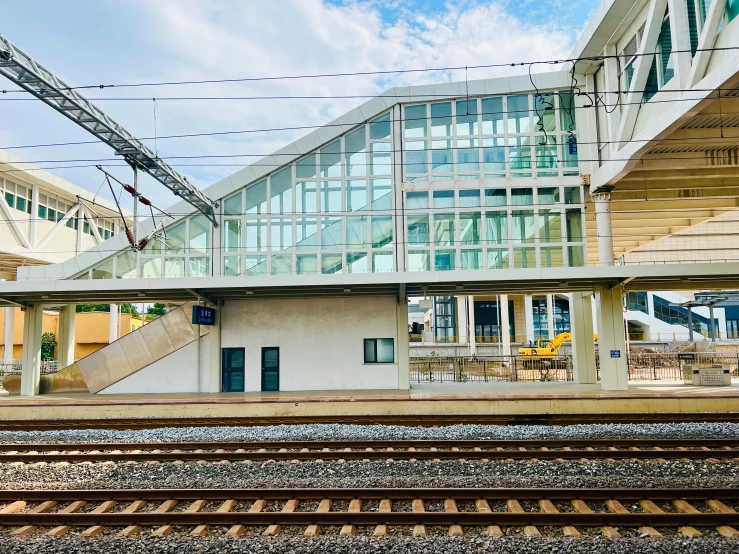 a passenger train in front of some glass building