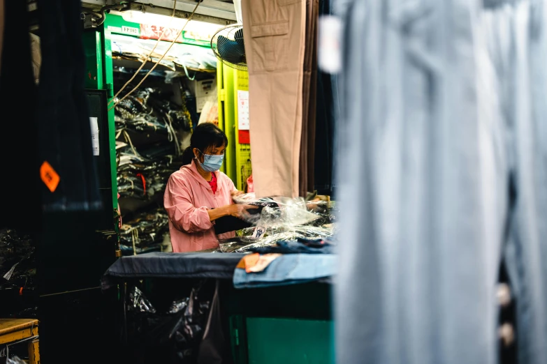 a woman works on sewing in her factory