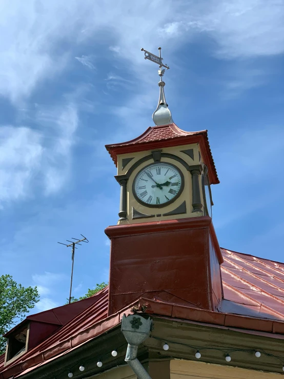 clock tower on top of a brown building under a blue sky