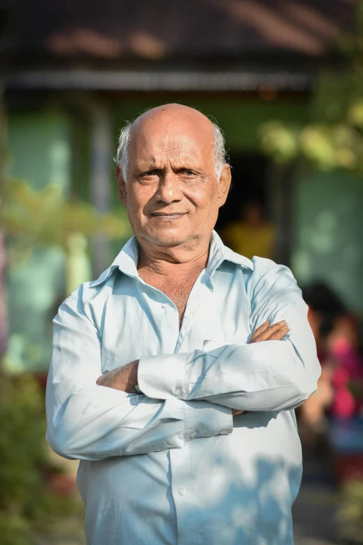 a man in a blue shirt and folded arms