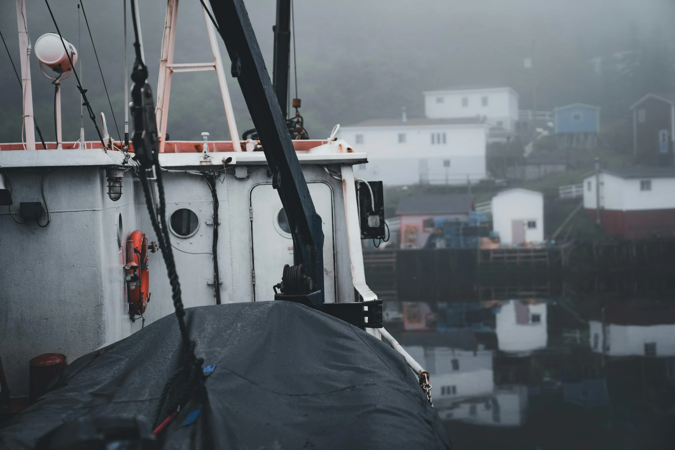 a boat sitting on a wet land near houses