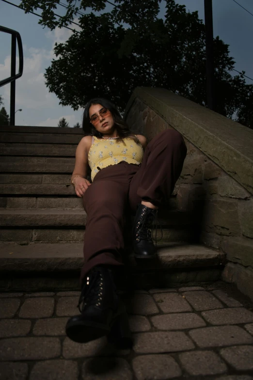 a woman is sitting on steps posing for the camera