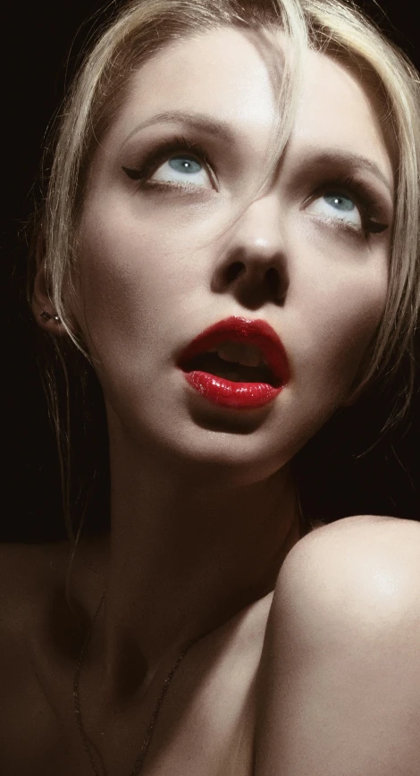 a woman with bright red lipstick looking up