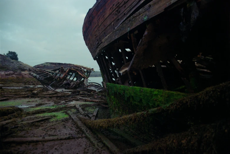 a large boat sitting on top of a dry grass covered beach