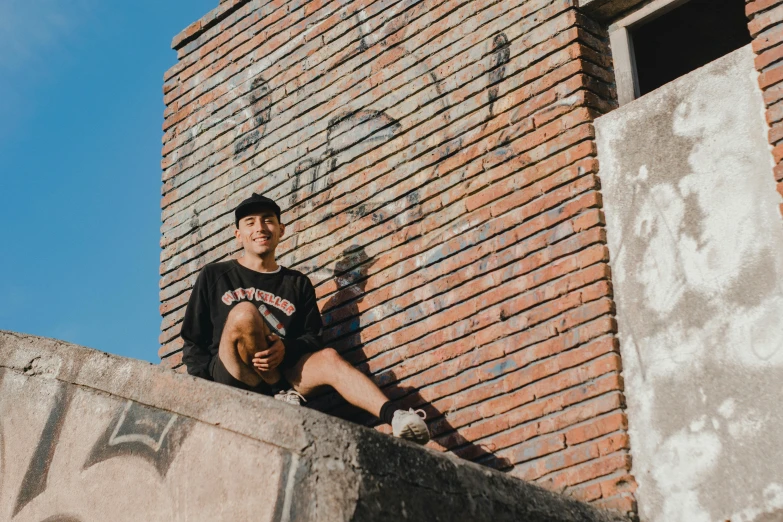 a person sitting on top of a concrete wall