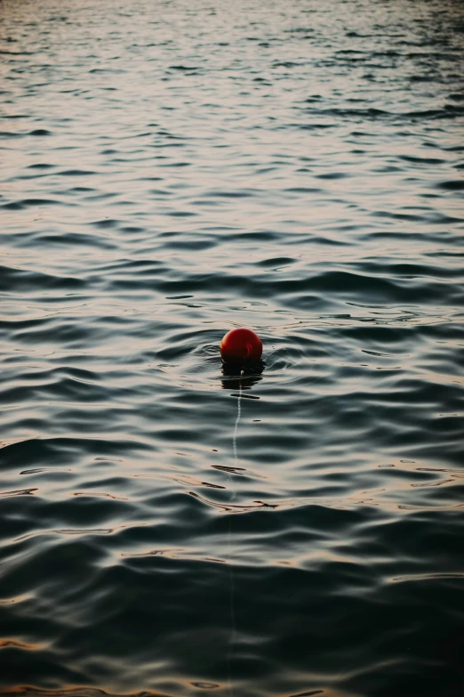 the red object is floating on top of the water