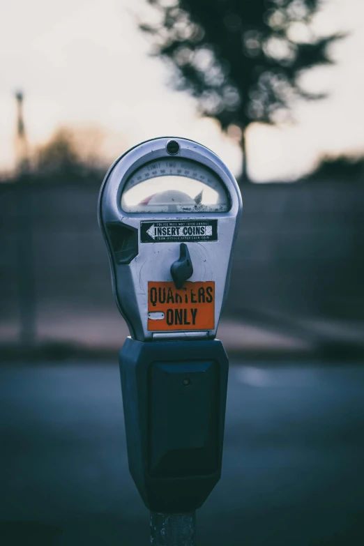 a coin meter sitting on the side of a road