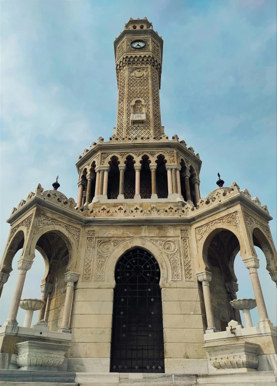 a large stone building with an ornate design around the top