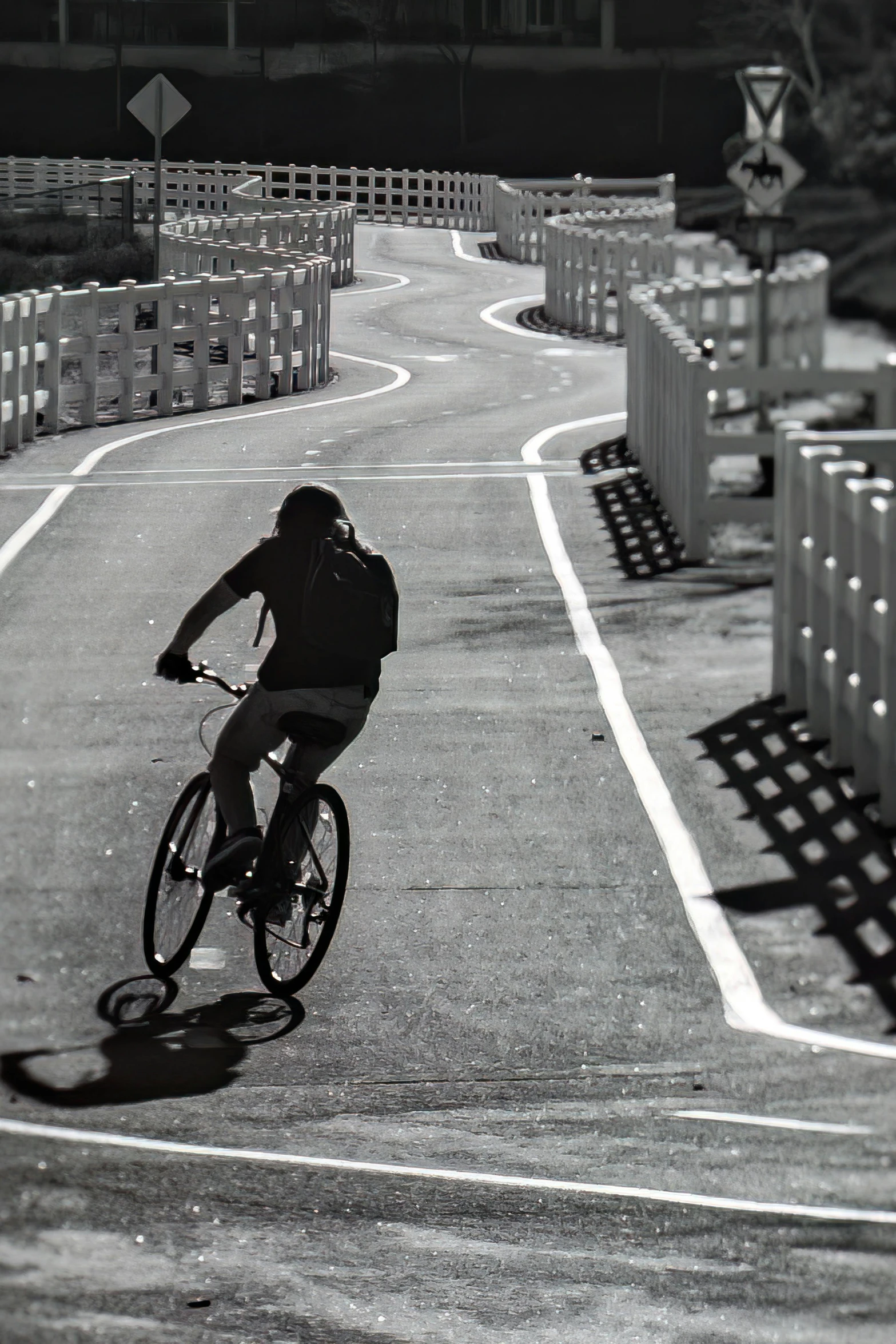 a man rides his bike along the road