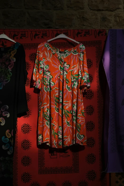 the dress in front of the colorful background is on display