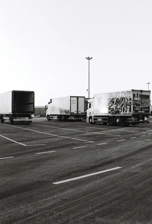 a number of trucks parked on a highway