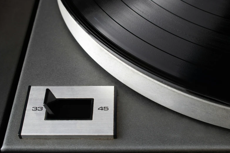 a turntable that has a silver and black label next to it