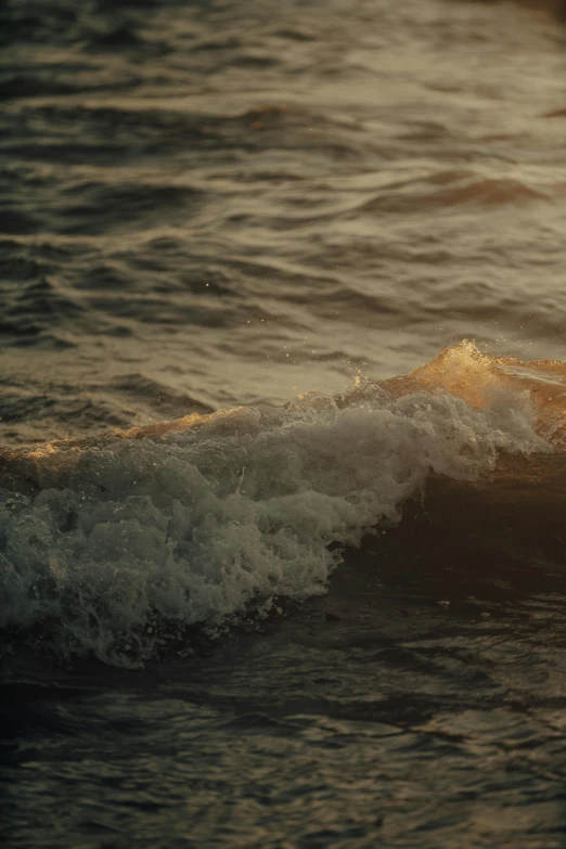 a man riding on top of a wave with a surfboard