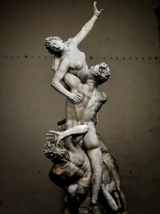 a statue that has four different men wrestling