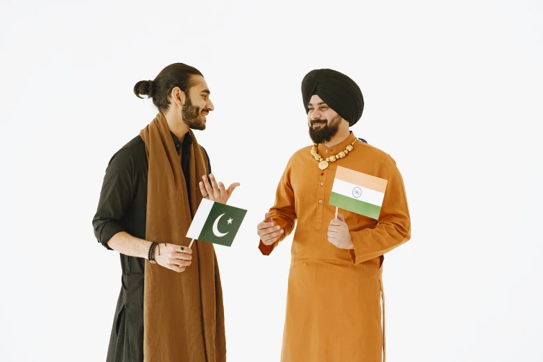 two men holding cards with the flag of pakistan