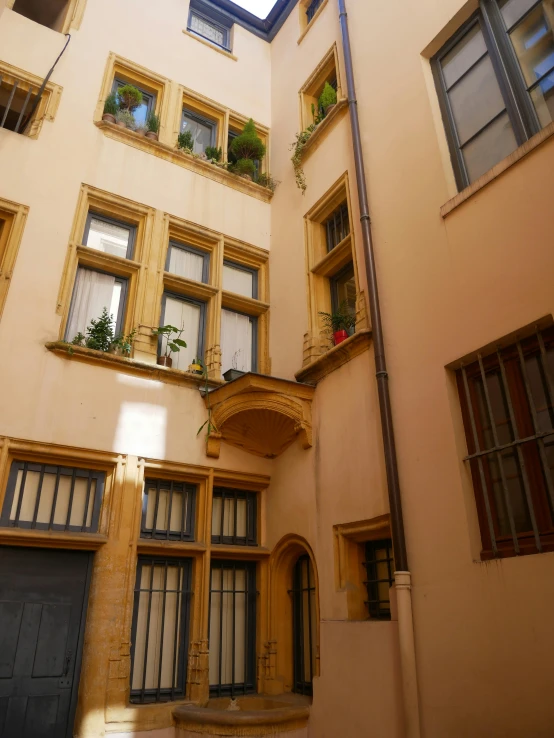 a view from the ground looking up at an old building with several windows