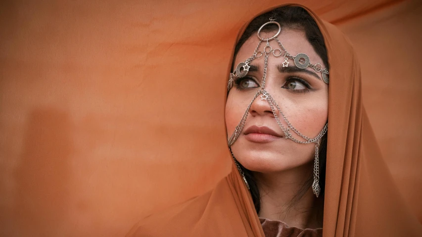 a beautiful woman in a shawl looking into the distance