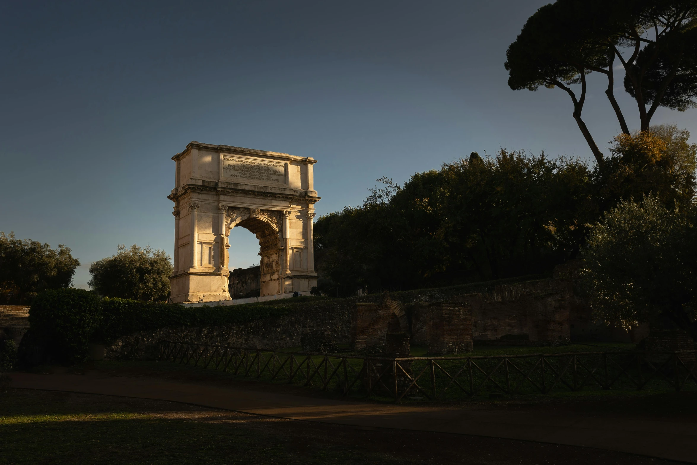 an old arch is illuminated with light on it