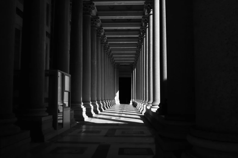 a black and white po of columns in an arch