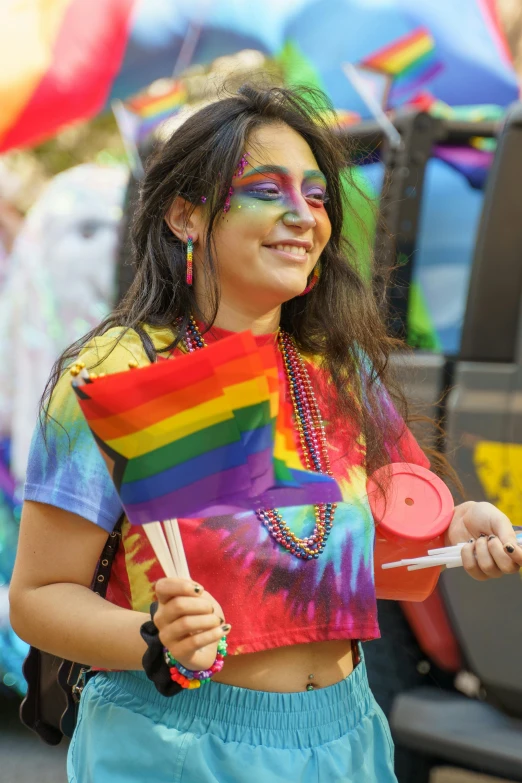 a child with face paint holding a piece of rainbow