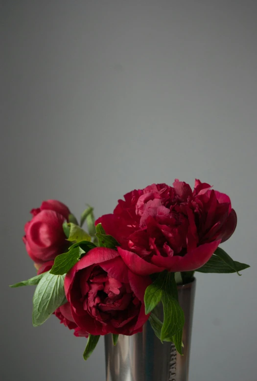 a flower is in a metal container on a table