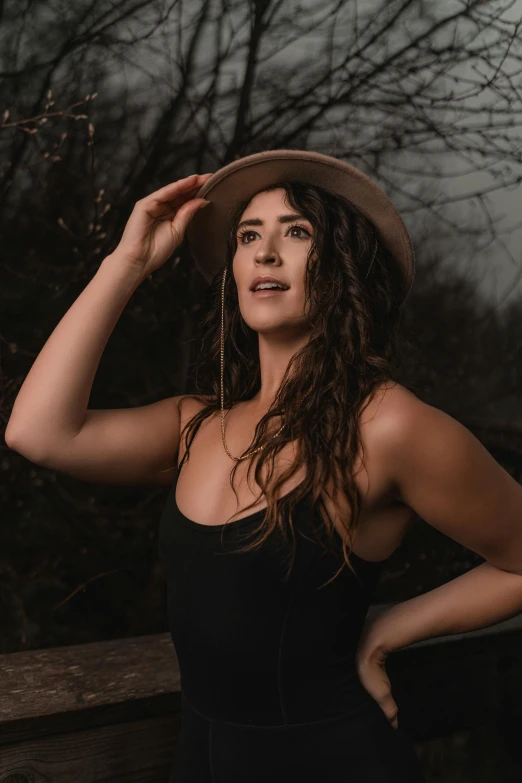 a woman wearing a hat while posing for a po