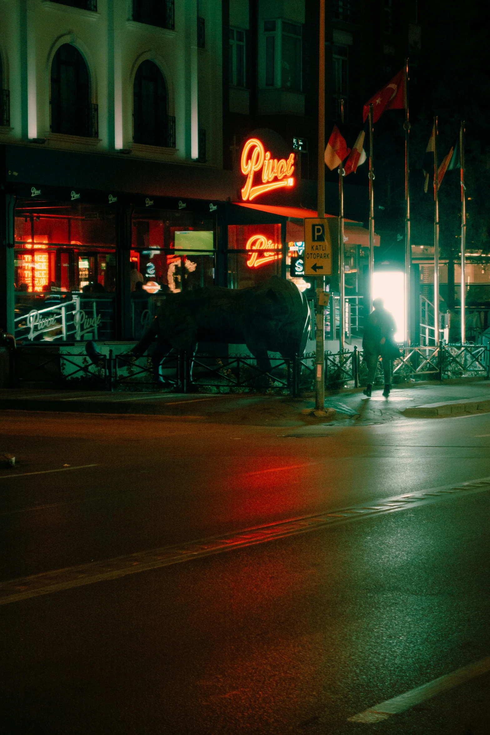 the people are standing on the street waiting at the bus stop