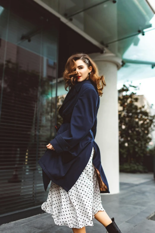 a woman standing on the side of the street