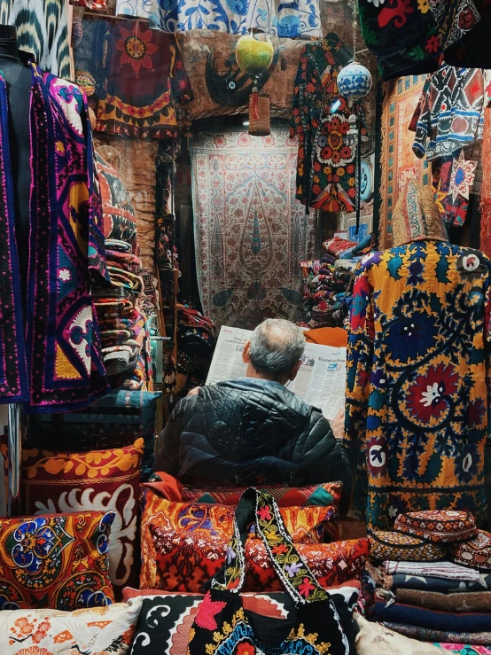 many handmade rugs and fabrics on display for sale