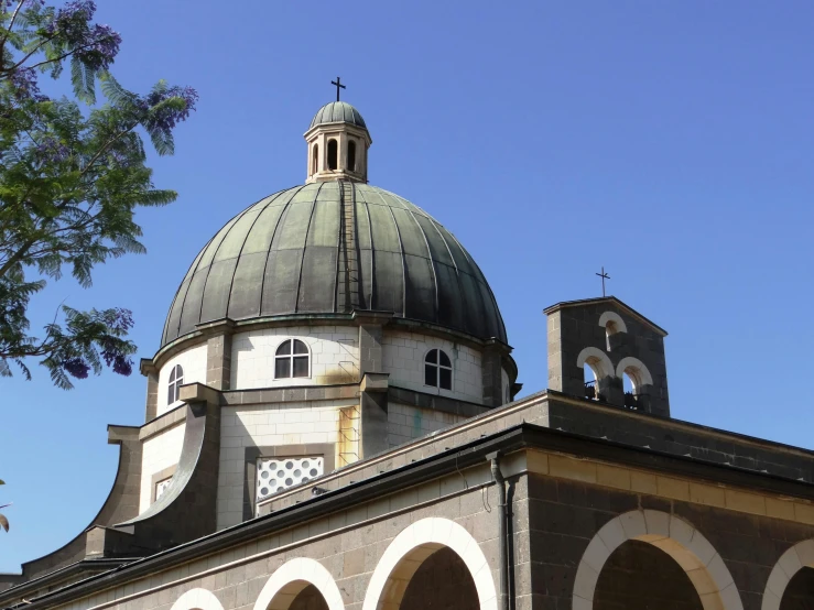 the dome of an old building that has arches and bell towers