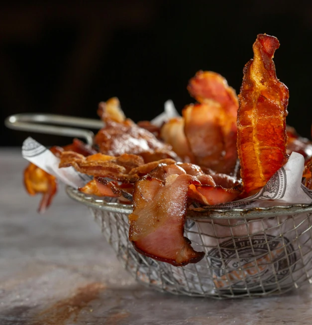 a basket full of bacon is on the table