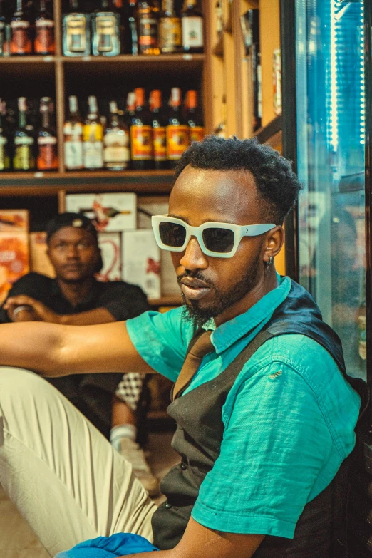 a man with shades is sitting at a counter